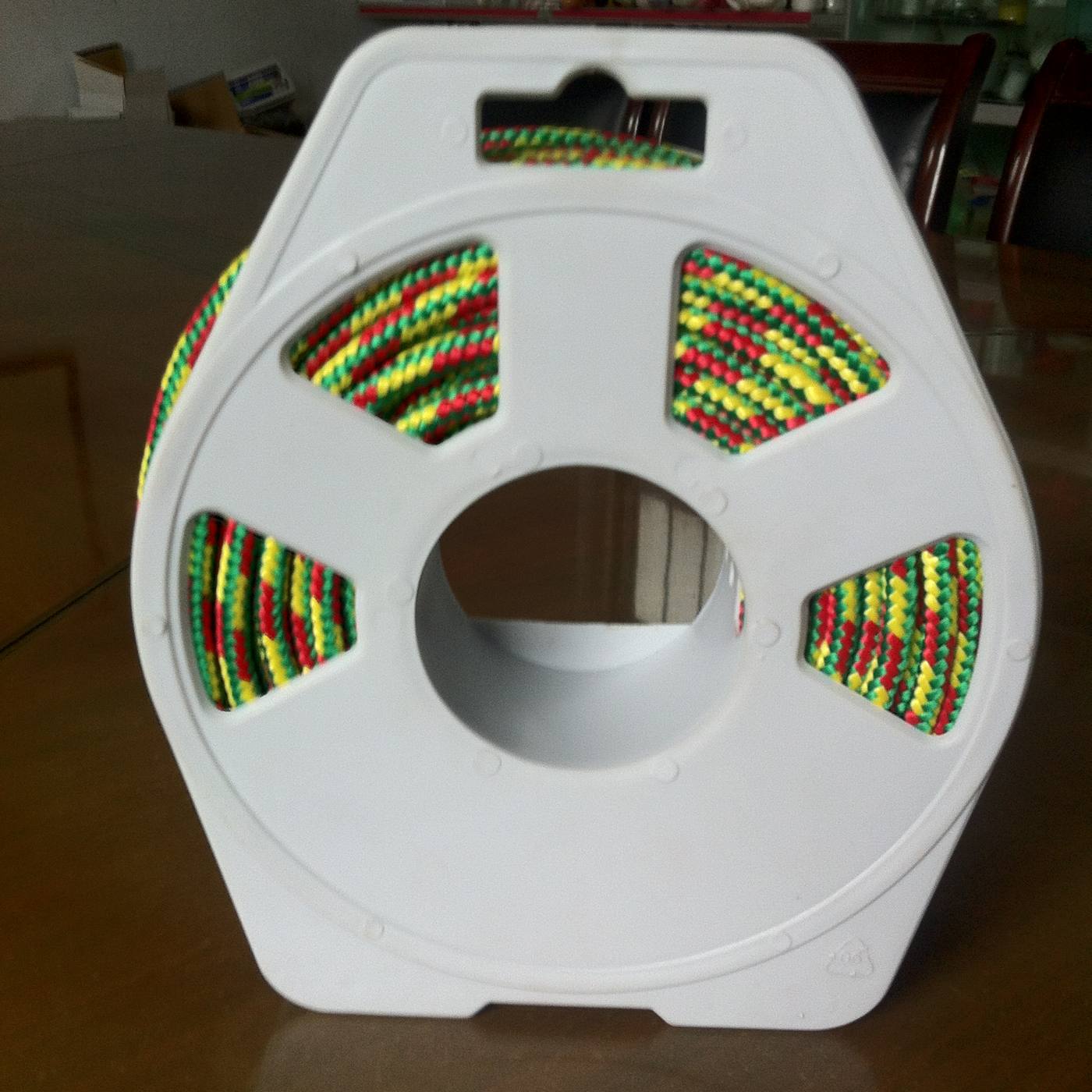 Multi-colour diamond-braided polypropylene rope wound on an unbranded plastic reel