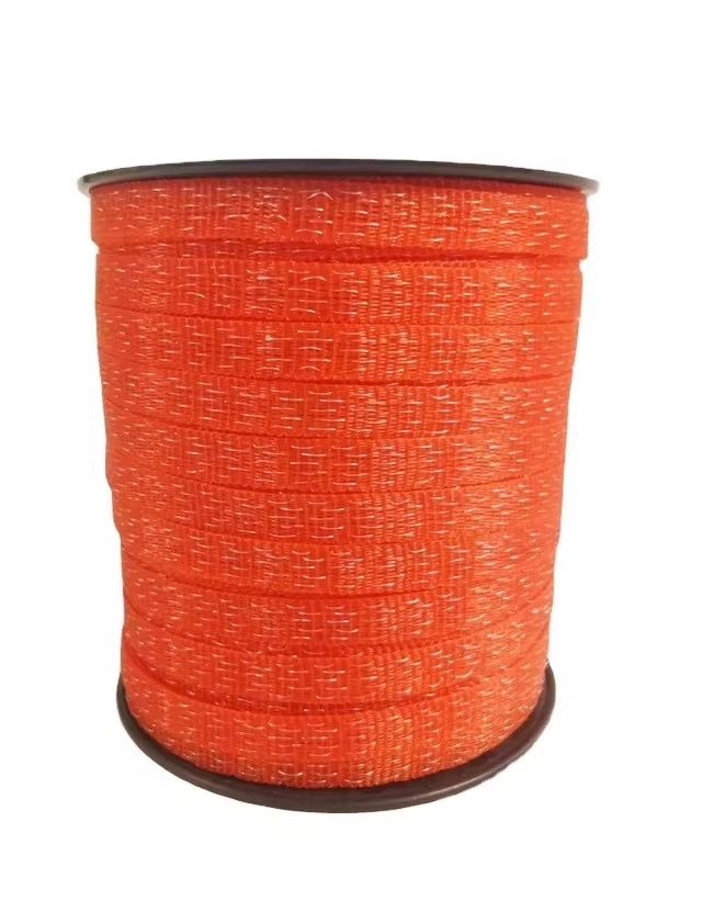Orange electric-fence polytape on a black plastic reel, full width