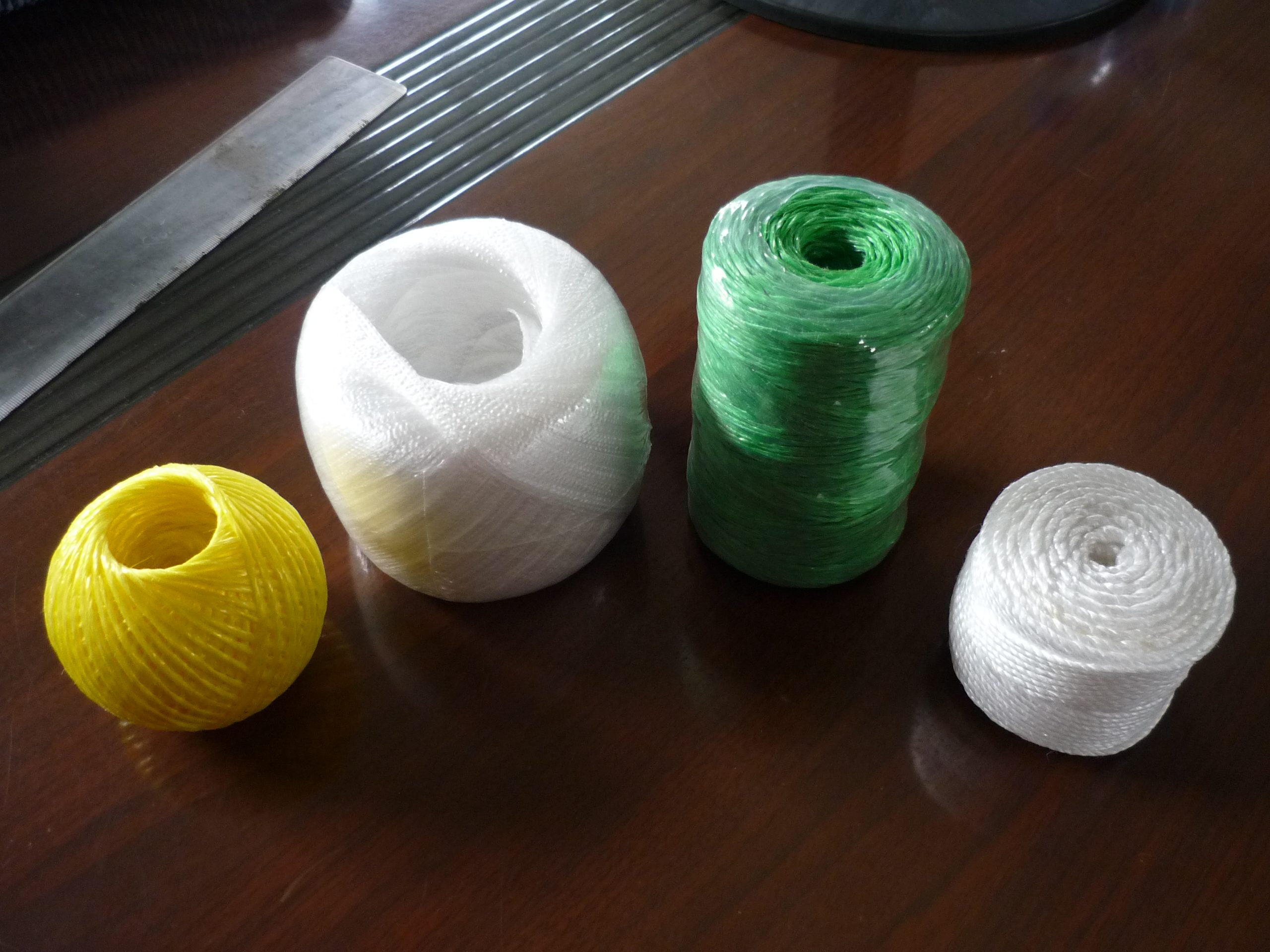 Polypropylene baler twine in multiple colors and spool formats — sample balls and small spools ready for the field